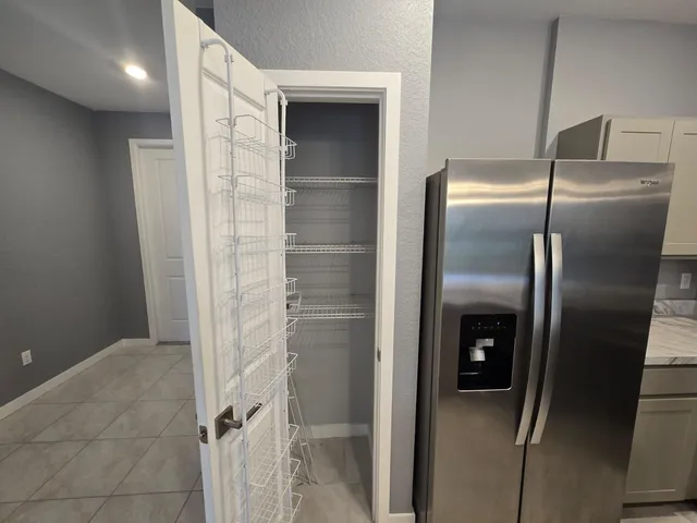 a kitchen with a refrigerator stainless steel appliances and cabinets