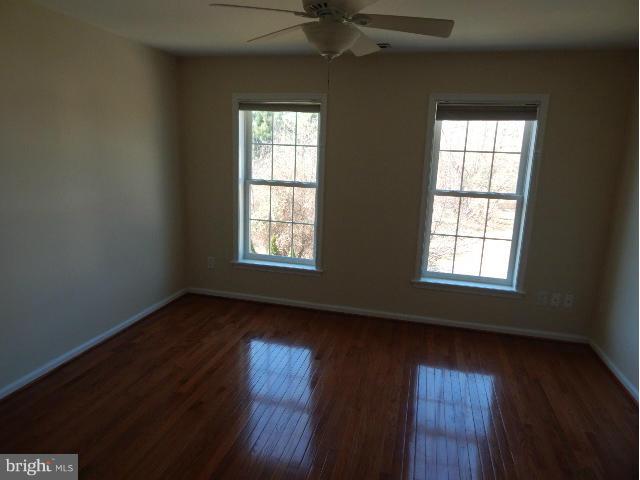 14813 Whitegate Road Silver Spring, MD 20905 - Photo 11 of 17 an empty room with wooden floor and windows