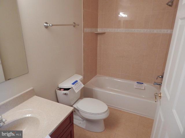 14813 Whitegate Road Silver Spring, MD 20905 - Photo 12 of 17 a white toilet sitting next to a bath tub