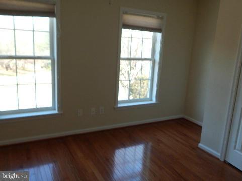 14813 Whitegate Road Silver Spring, MD 20905 - Photo 13 of 17 an empty room with wooden floor and windows