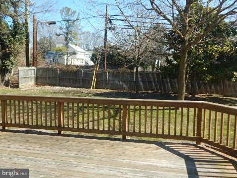 14813 Whitegate Road Silver Spring, MD 20905 - Photo 15 of 17 a view of a balcony with a floor to ceiling window and wooden fence