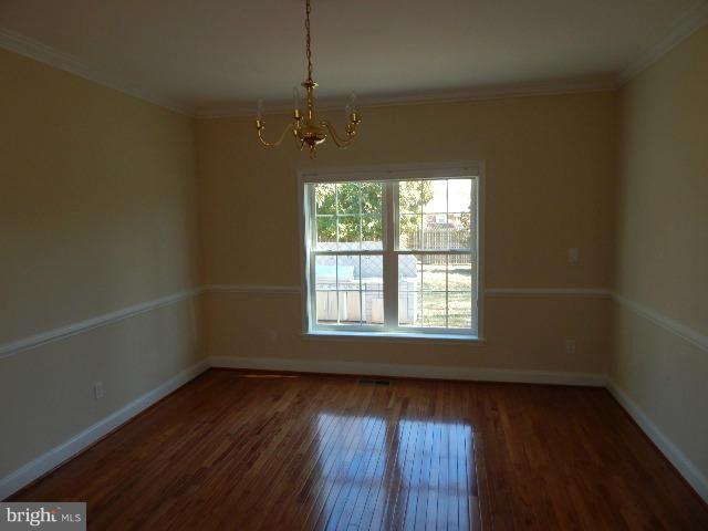 14813 Whitegate Road Silver Spring, MD 20905 - Photo 3 of 17 an empty room with wooden floor and windows