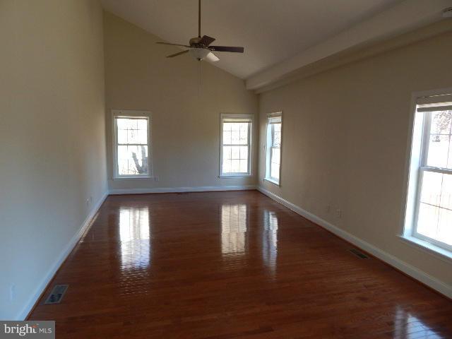 14813 Whitegate Road Silver Spring, MD 20905 - Photo 5 of 17 a view of an empty room with wooden floor and a window