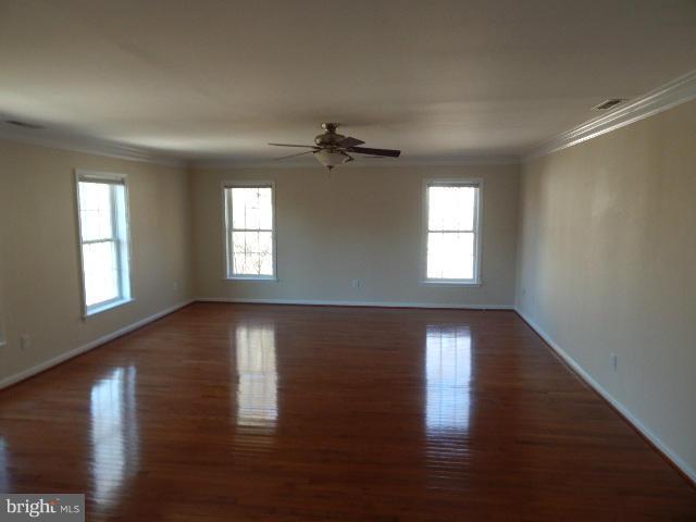 14813 Whitegate Road Silver Spring, MD 20905 - Photo 6 of 17 a view of an empty room with wooden floor and a window