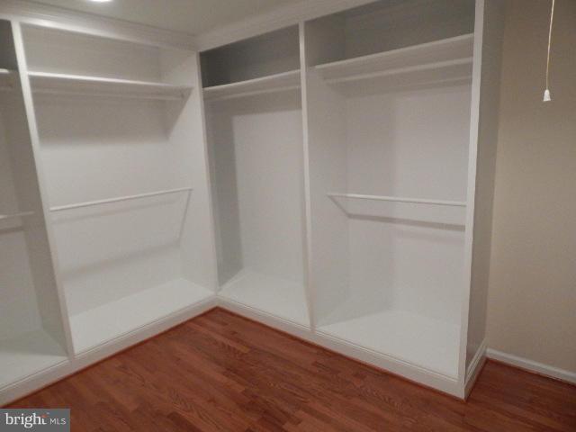 14813 Whitegate Road Silver Spring, MD 20905 - Photo 10 of 17 a view of an empty walk in closet with wooden floor