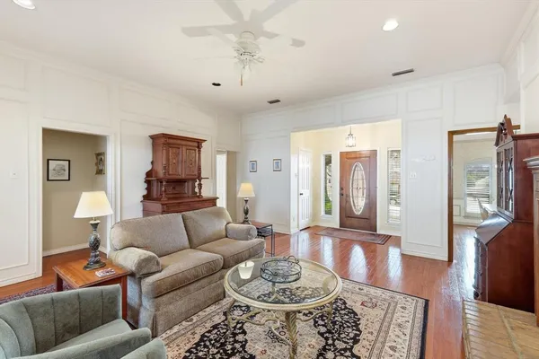 a living room with furniture a fireplace and wooden floor