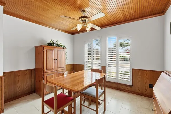 a dining room with furniture and window