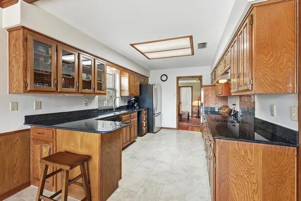 a kitchen with stainless steel appliances granite countertop a sink and cabinets