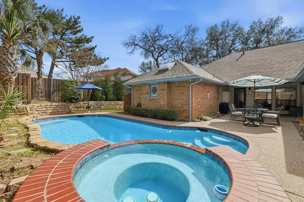 a swimming pool with outdoor seating and yard