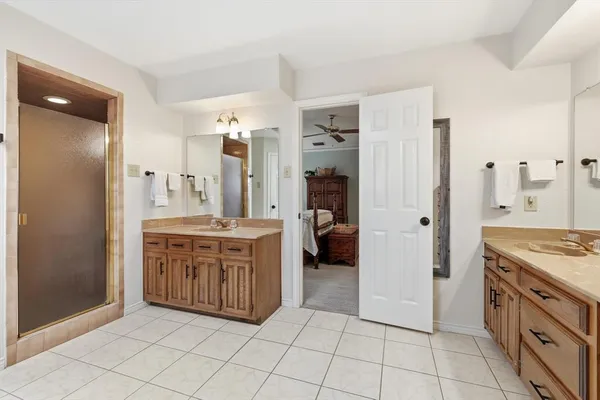 a bathroom with a granite countertop sink vanity and a mirror