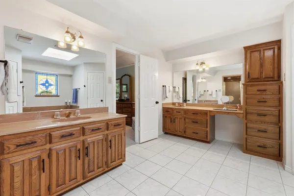 a bathroom with a granite countertop sink a mirror and a shower