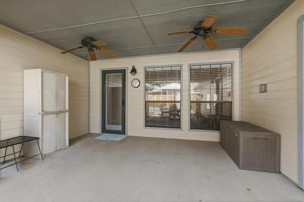 a view of a patio with table and chairs under an umbrella