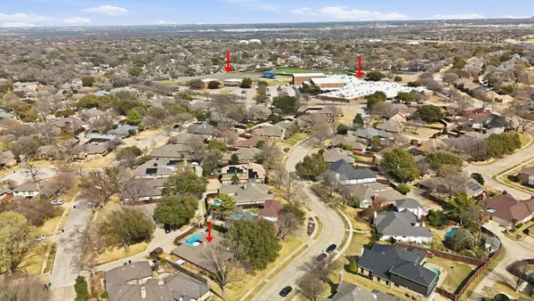 a front view of a house with a yard covered in snow