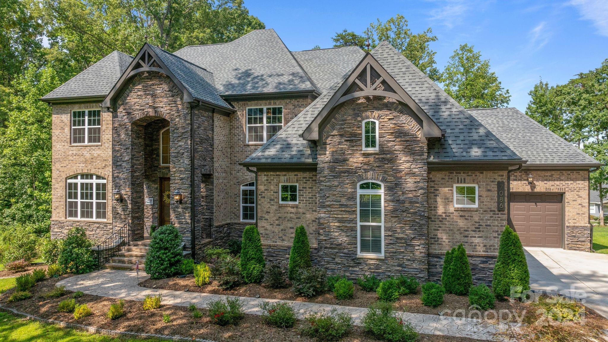 7086 Hawk Shadow Denver, NC 28037 - Photo 4 of 48 a front view of a house with garden