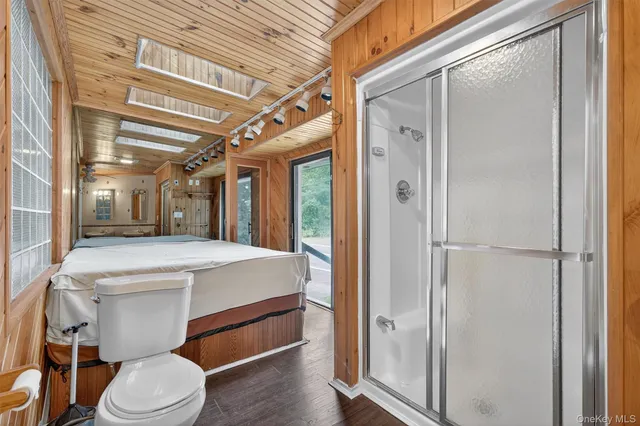 a bathroom with a sink a toilet and shower