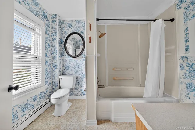 a bathroom with a toilet a sink and a shower