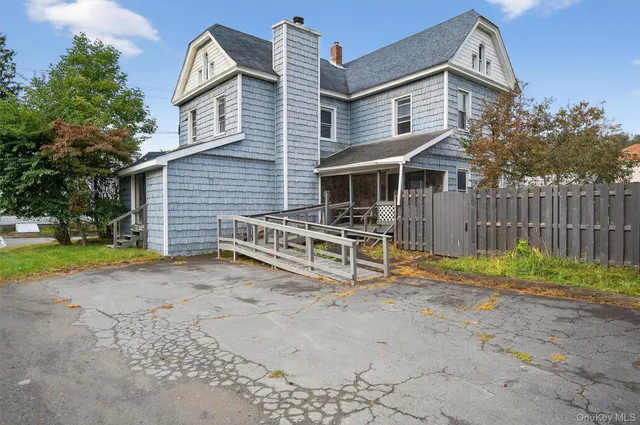 a view of backyard with deck and trees