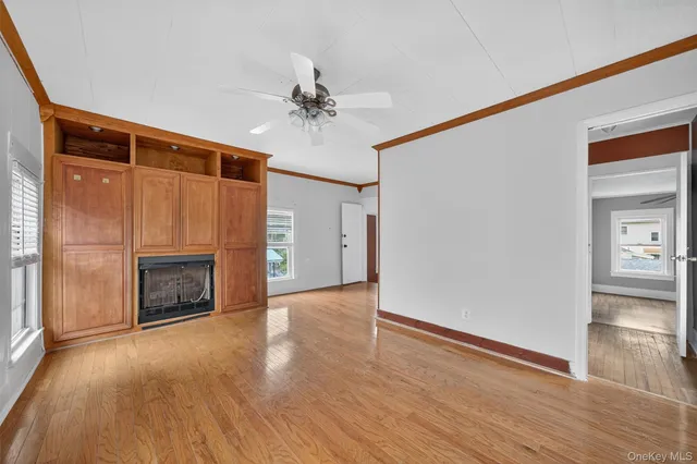 a view of an empty room with a fireplace and a window