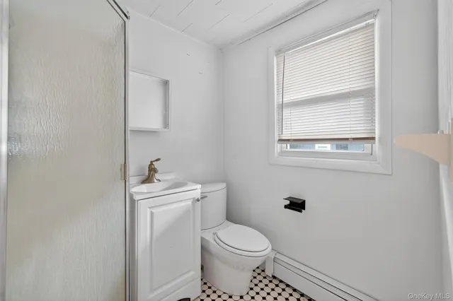 a white toilet sitting next to a bathroom sink