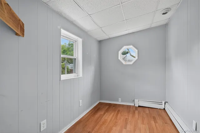 a view of room with window and wooden floor