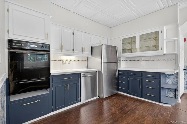 a kitchen with stainless steel appliances granite countertop a refrigerator stove and cabinets