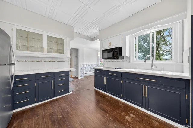 a kitchen with stainless steel appliances granite countertop a sink dishwasher stove and wooden cabinets