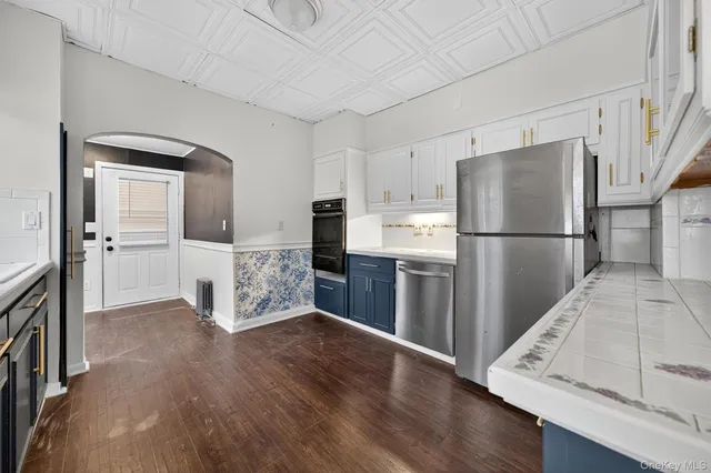 a kitchen with stainless steel appliances a refrigerator sink and cabinets