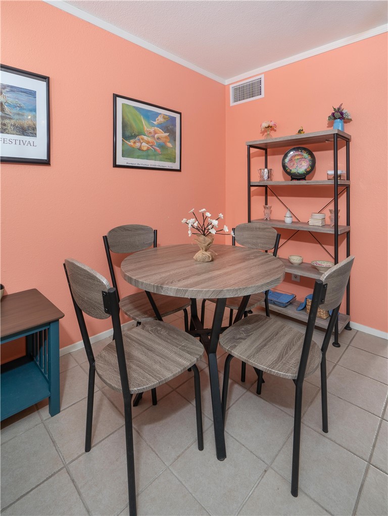 2290 North Fulton Beach Road Rockport, TX 78382 - Photo 16 of 26 a view of a dining room with furniture and window