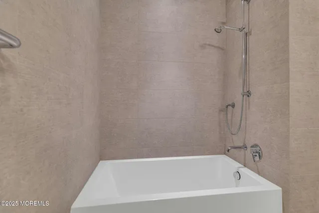 a white bath tub sitting in a bathroom