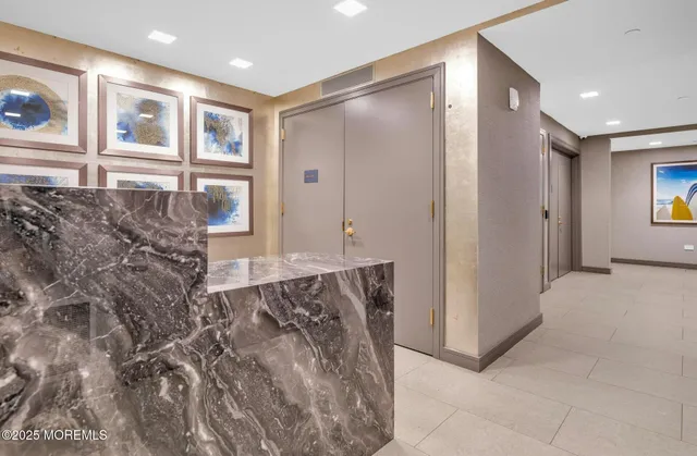 a spacious bathroom with a glass shower door and a window