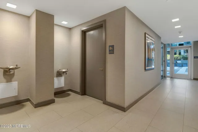 a view of a hallway with bathroom