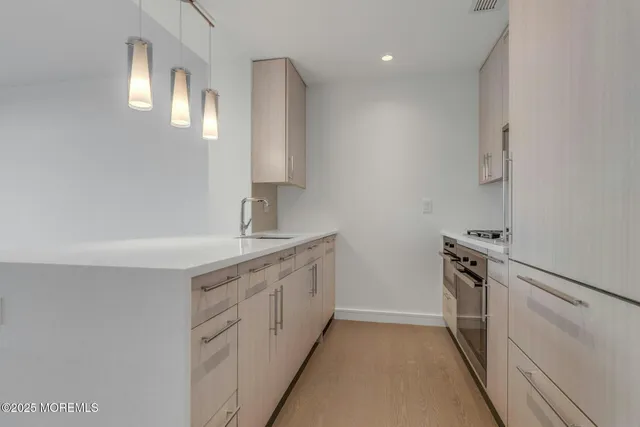 a kitchen with a sink stove and cabinets