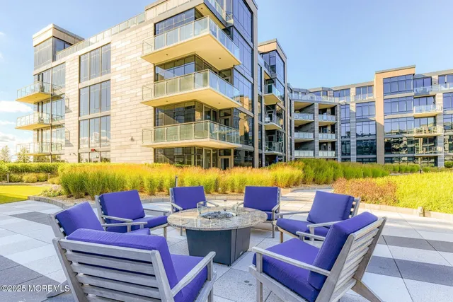 a view of a swimming pool with a couches and lounge chairs