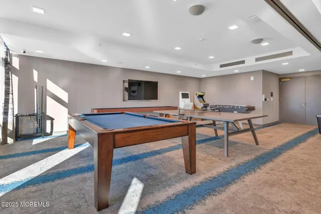 a view of a room with furniture and wooden floor