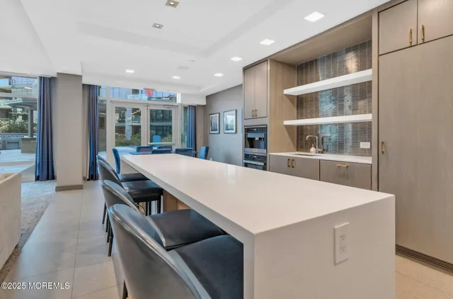 a kitchen with kitchen island a sink table and chairs