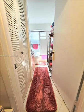 a hallway with front door and stairs