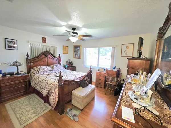 a bedroom with a bed a couch and dresser