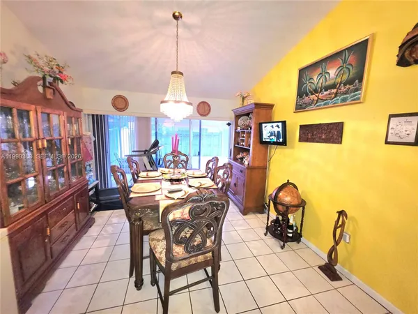 a view of a dining room with furniture and chandelier