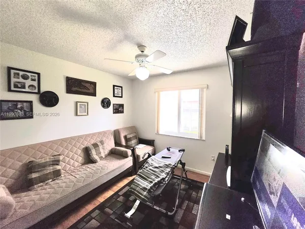a living room with couches and a flat screen tv