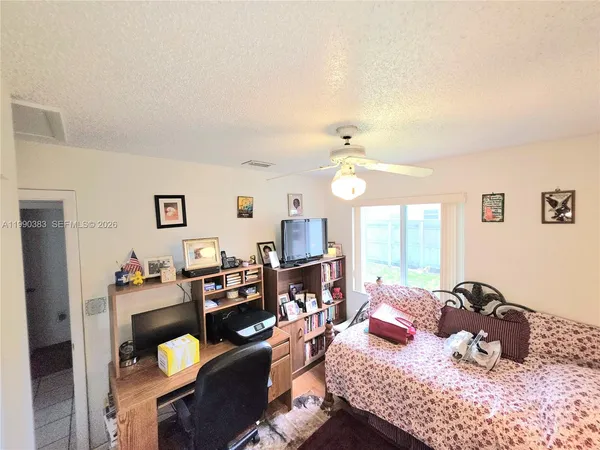 a bedroom with furniture and a wooden floor