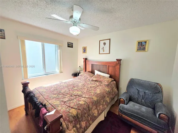 a bedroom with a bed couch and window