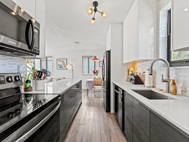a kitchen with stainless steel appliances a sink stove and refrigerator