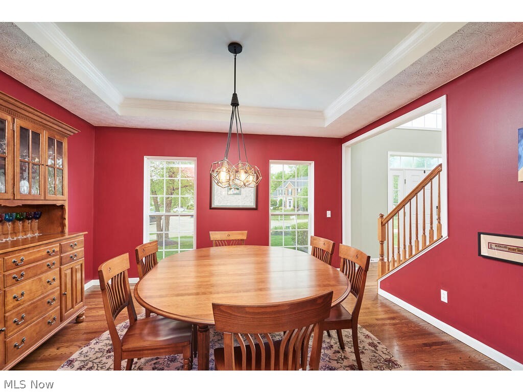 5172 Shillings Way Akron, OH 44321 - Photo 8 of 26 Dining room with ornamental molding, dark hardwood / wood-style flooring, a tray ceiling, and an inviting chandelier
