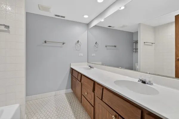 a bathroom with a double vanity sink and mirror