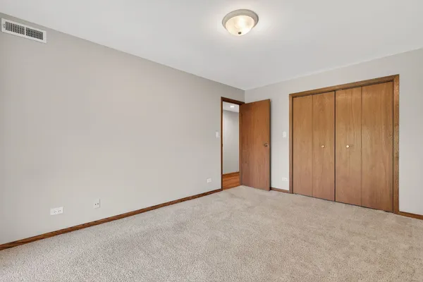 an empty room with closet area