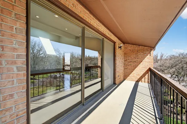 a view of a balcony with wooden floor