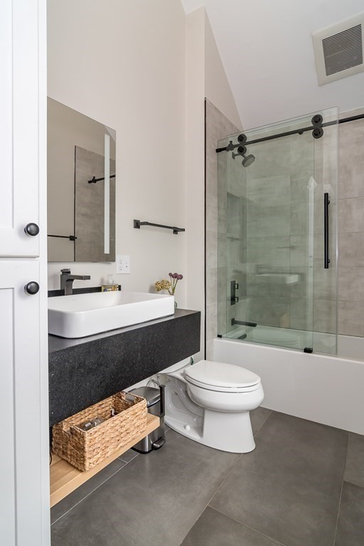1 Roberts Road Wellesley, MA 02481 - Photo 23 of 29 a bathroom with a sink a toilet a mirror a bathtub and shower