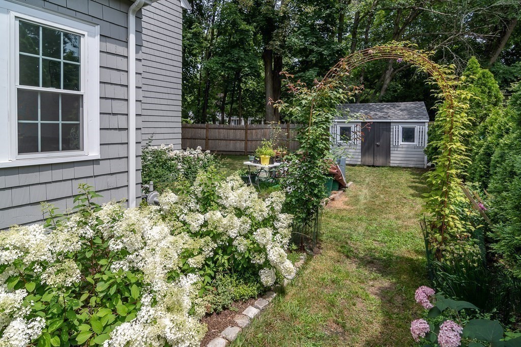 1 Roberts Road Wellesley, MA 02481 - Photo 25 of 29 a view of a garden with a house in the background