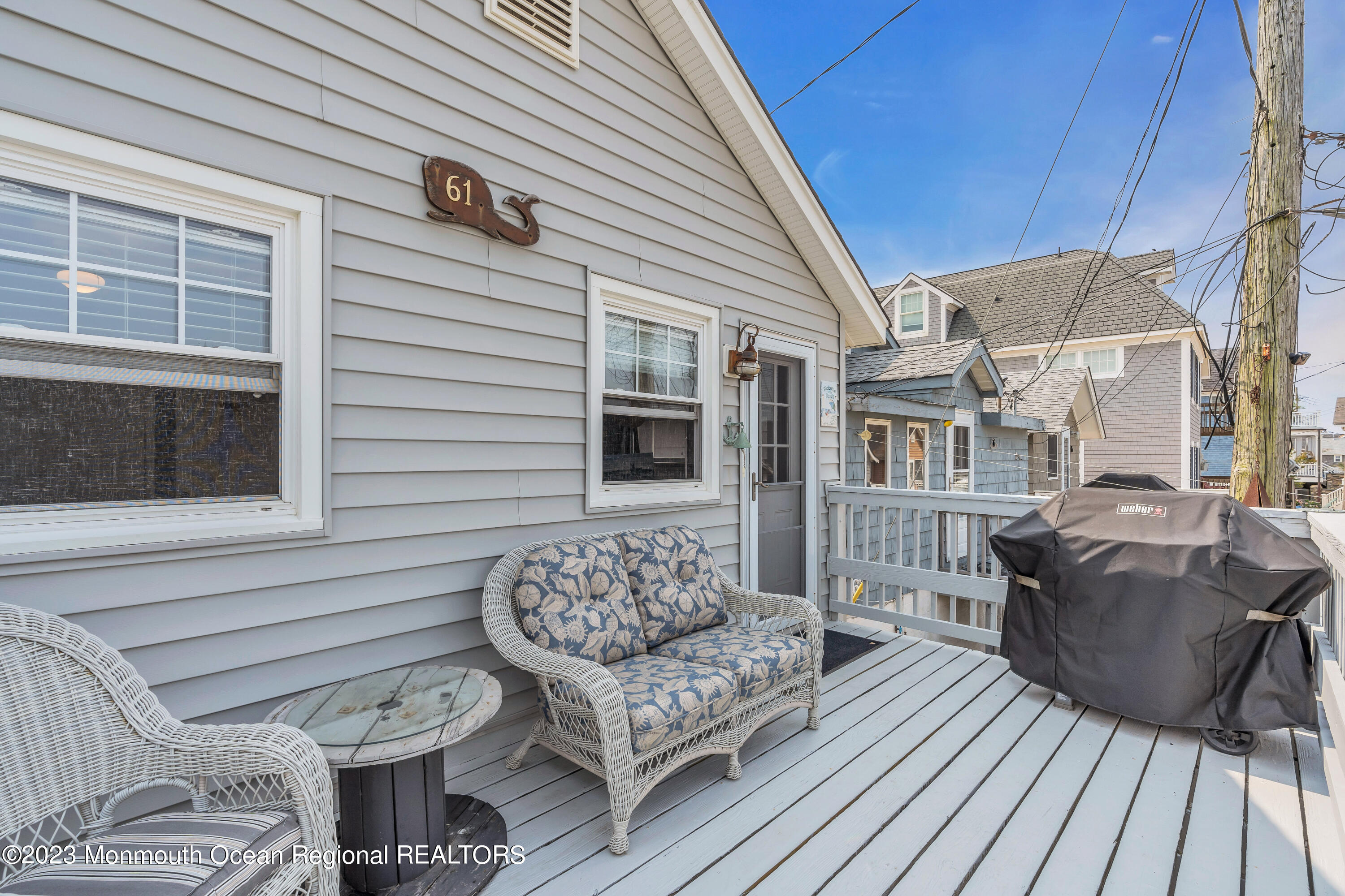 61 Beach Front Manasquan, NJ 08736 - Photo 18 of 20 a view of a patio with couches chairs potted plants and wooden floor