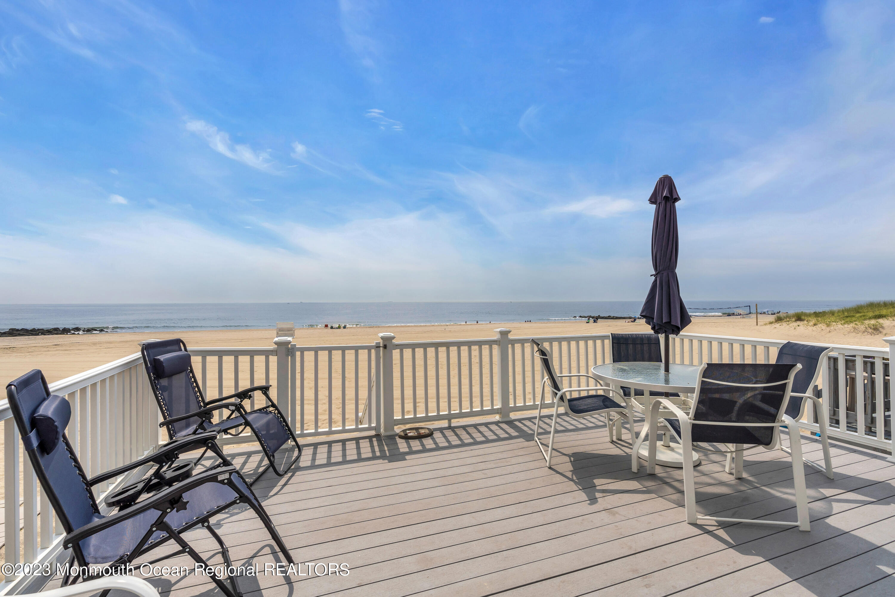 61 Beach Front Manasquan, NJ 08736 - Photo 19 of 20 a view of a balcony with furniture and wooden floor
